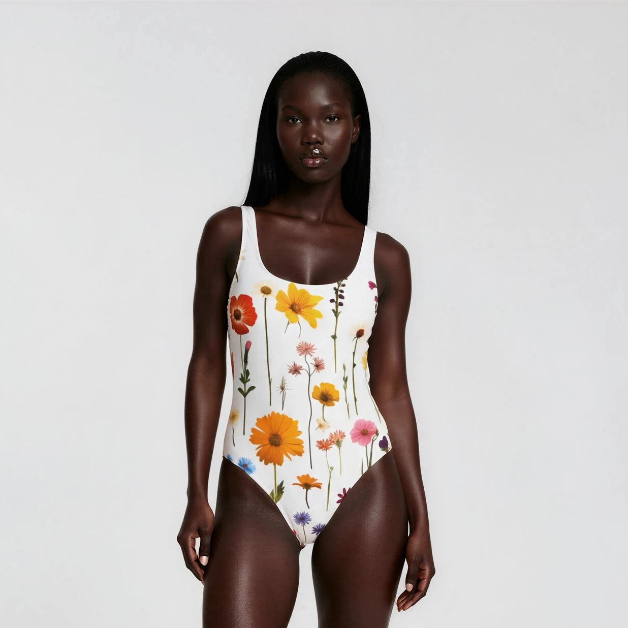 Model wearing a floral swimsuit on a white background