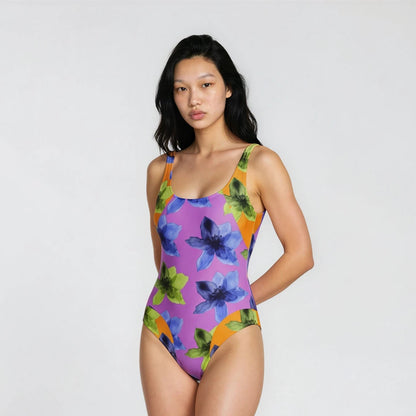 Woman wearing a colorful floral swimsuit on a white background