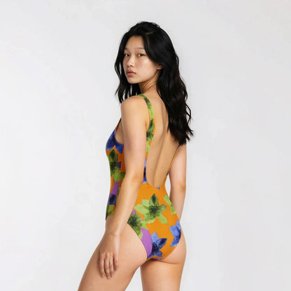 Woman wearing a colorful floral swimsuit on a white background