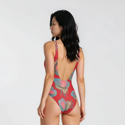 Woman wearing a red patterned swimsuit on a white background