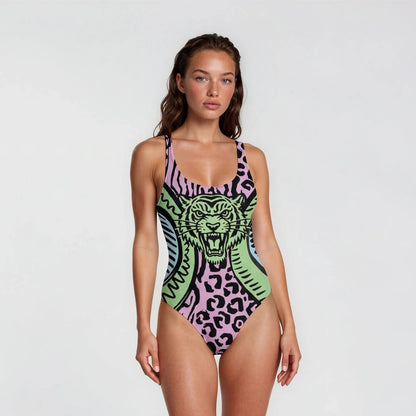 Woman wearing a colorful swimsuit with a fierce animal design on a white background
