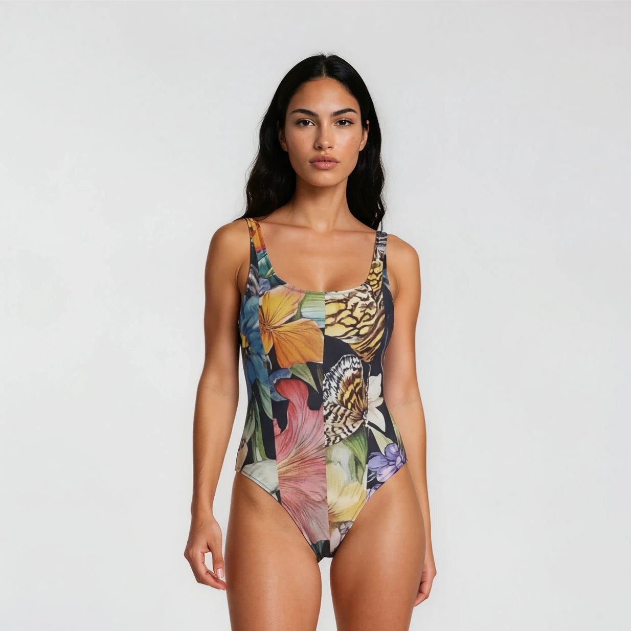 Woman wearing a colorful floral swimsuit on a white background
