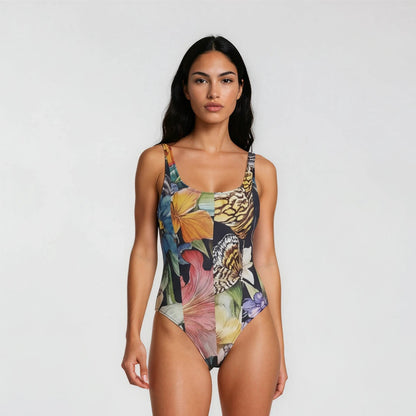 Woman wearing a colorful floral swimsuit on a white background