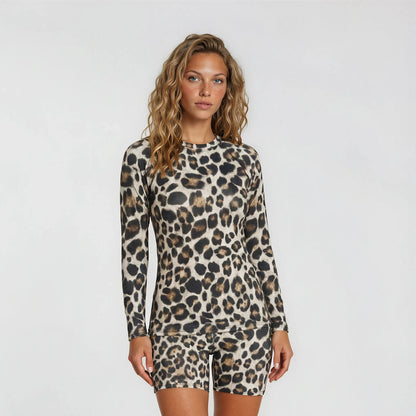 Woman wearing a leopard print long-sleeve romper on a white background