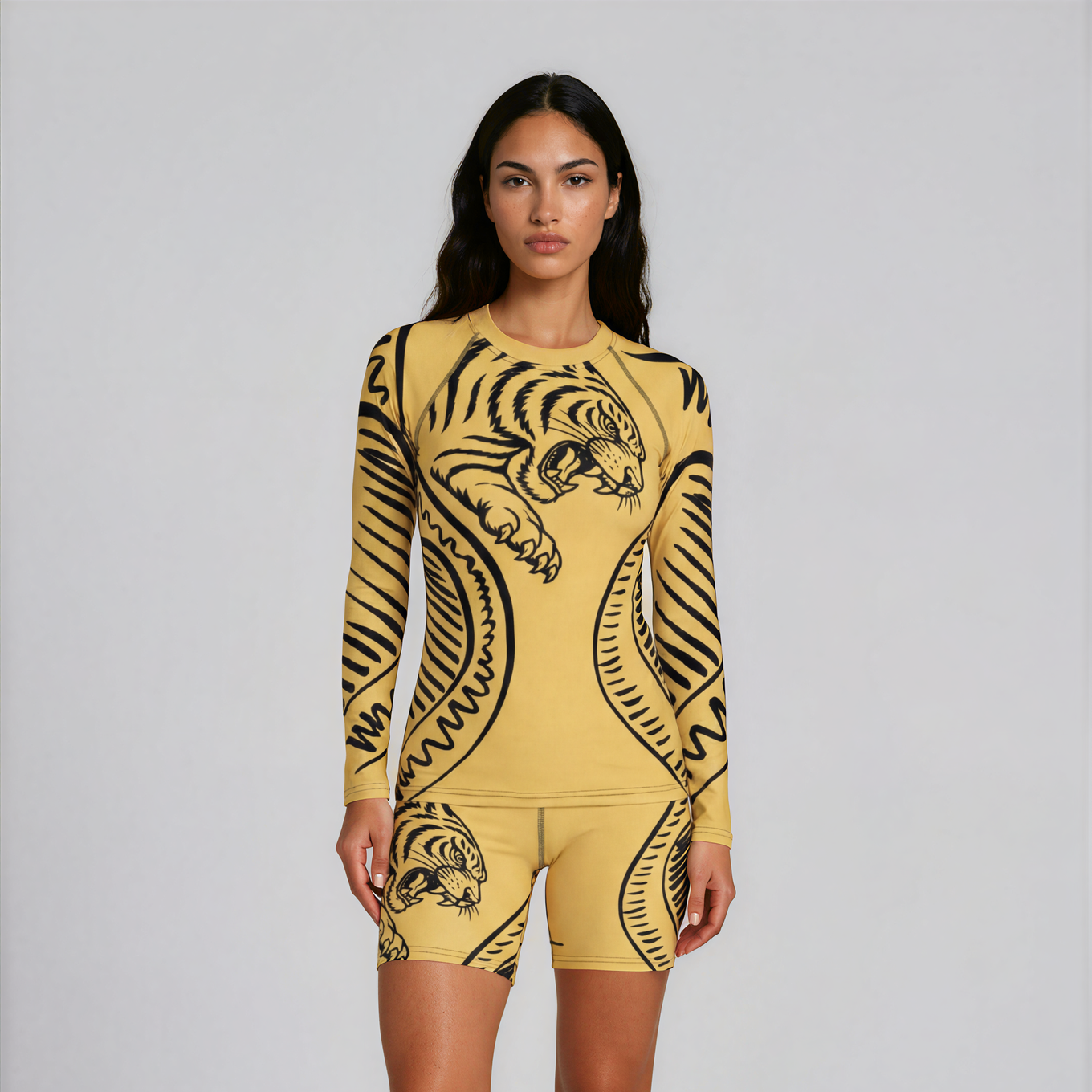 Woman wearing a yellow and black tiger-patterned outfit on a white background