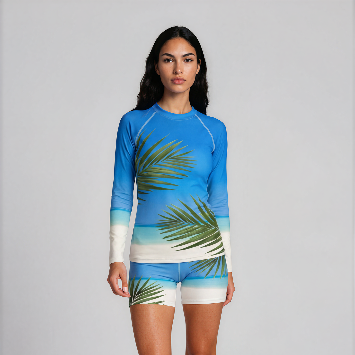 Woman wearing a blue and green patterned swimsuit on a white background