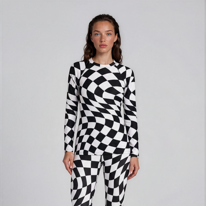 Person wearing a black and white checkered onesie on a plain background