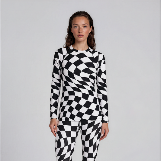 Person wearing a black and white checkered onesie on a plain background