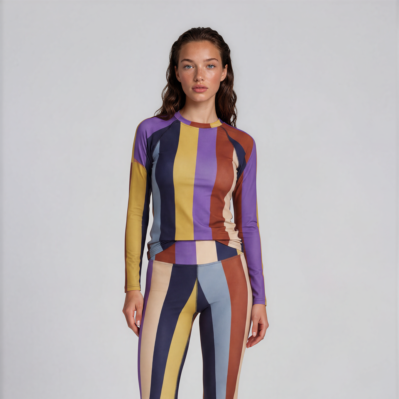 Model wearing a colorful striped outfit on a white background